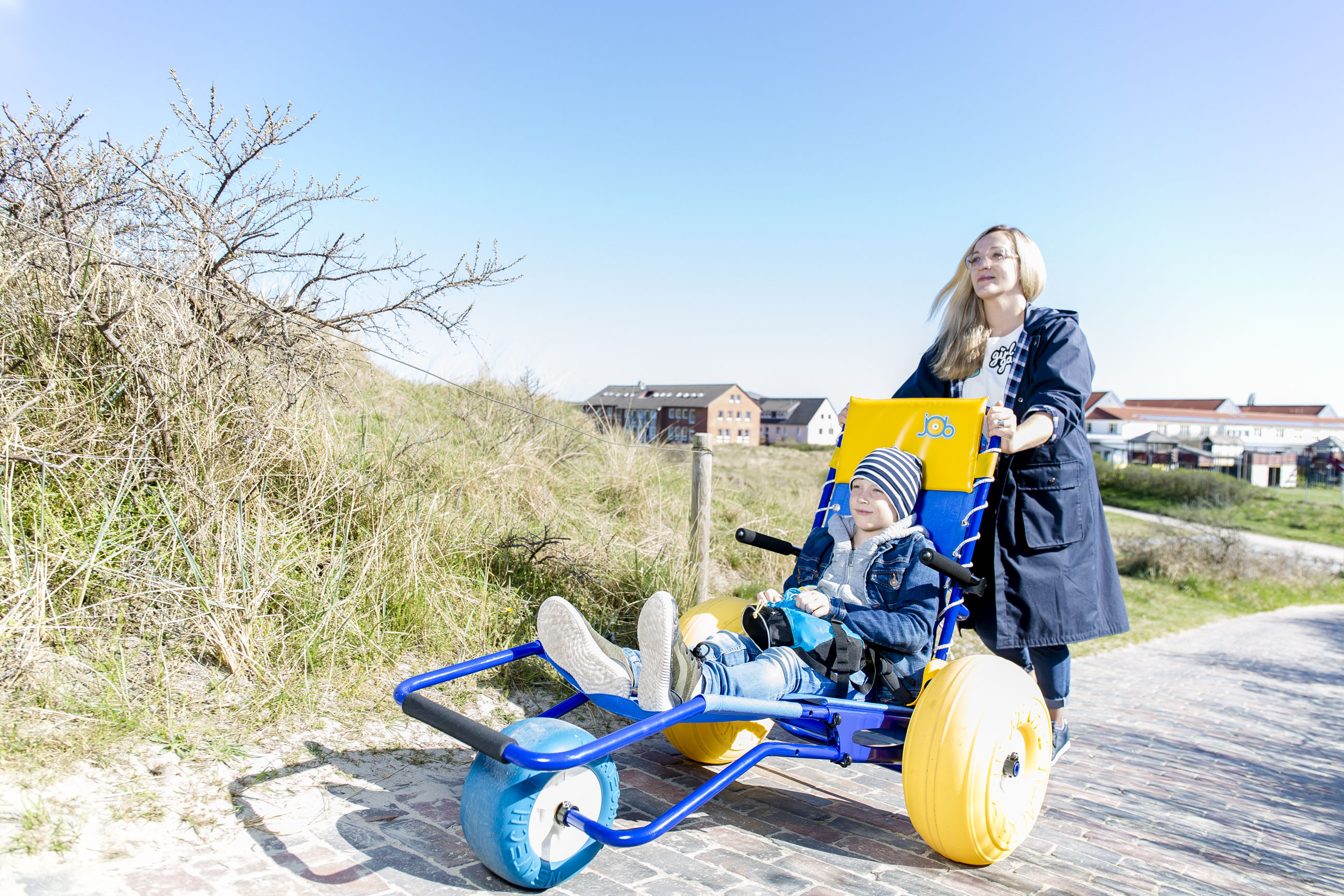 Eine Mutter fährt ihr Kind auf Langeoog spazieren