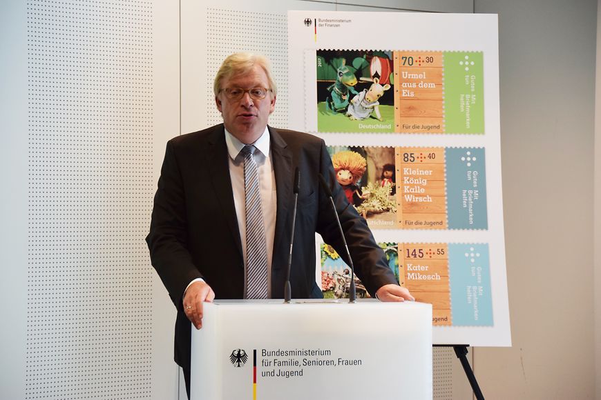 Dr. Ralf Kleindiek steht am Rednerpult im Hintergrund ein Aufsteller mit den drei Jugendmarken 2017