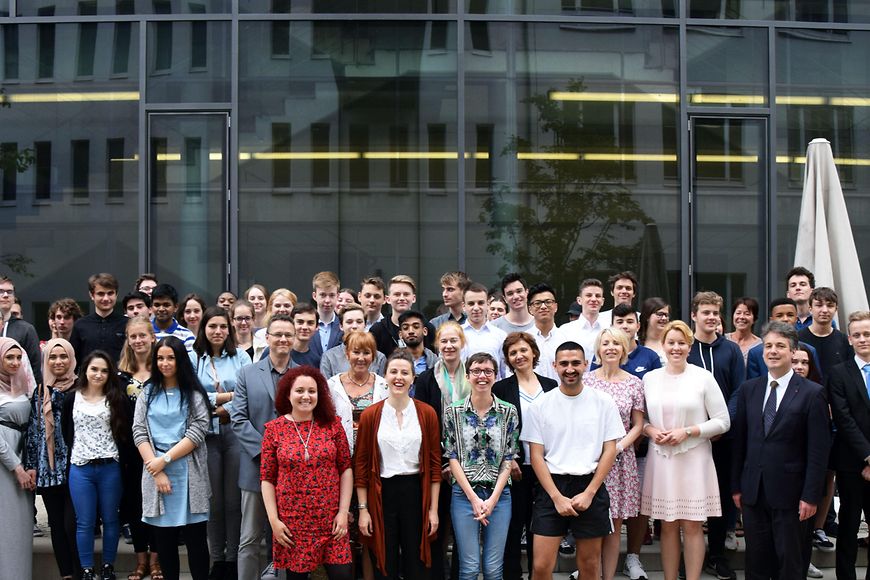Ein Gruppenbild mit etwa 80 Personen im Innenhof des Ministeriums