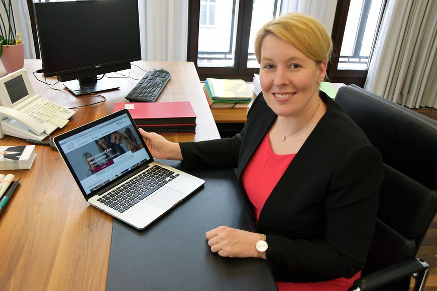 Das Bild zeigt Franziska Giffey an einem Schreibtisch, wo sie die neue Internetseite präsentiert