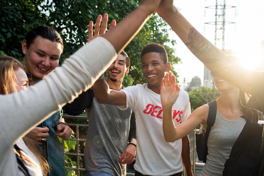 Junge Leute klatschen sich mit den Händen ab