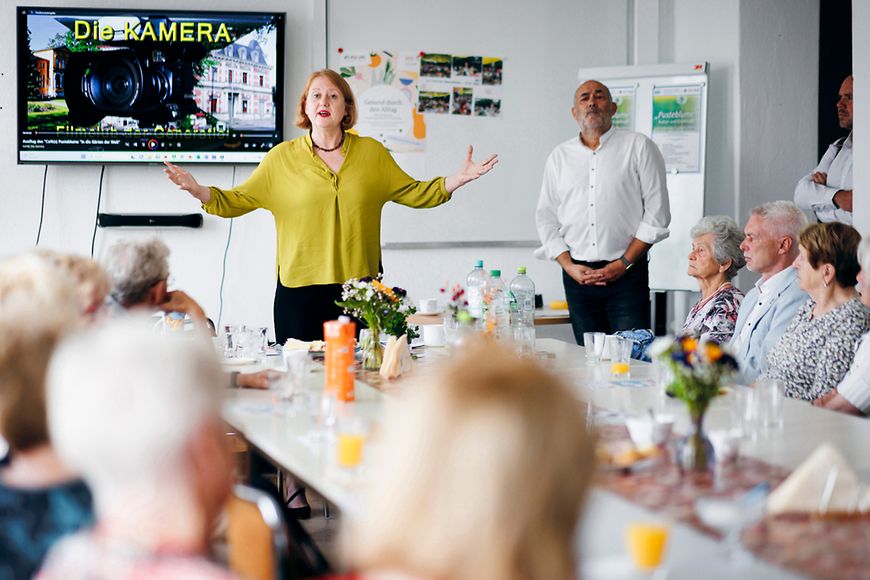 Lisa Paus mit Seniorinnen und Senioren bei ihrem Besuch in der Lokalen Allianz für Menschen mit Demenz