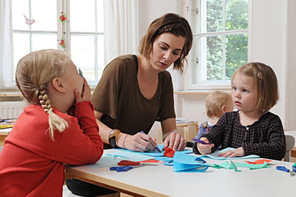 Kita-Erzieherin mit Kindern beim Basteln. Bildquelle: Meike Gronau