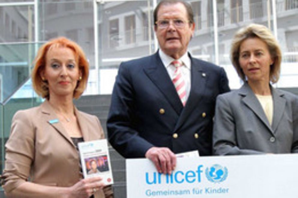 Regine Stachelhaus steht neben Sir Roger Moore und Ministerin Ursula von der Leyen