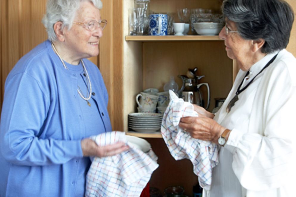Zwei ältere Frauen stehen vor einem Geschirrschrank. Bildnachweis: BMFSFJ